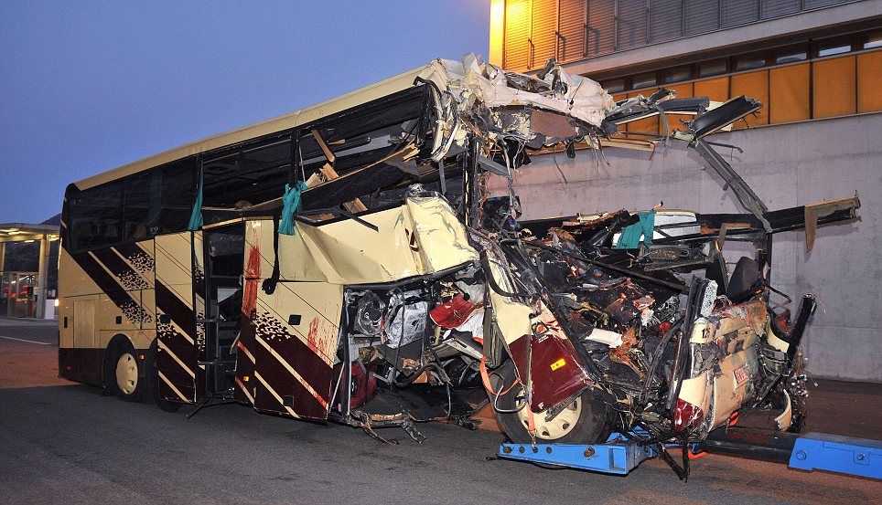 Carnage: Bloodstains can be seen down the side of the wrecked vehicle as it is towed away 